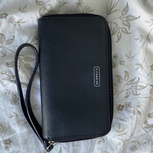 Small Coach wristlet. Black leather. 6inches by 3.5 inches in dimensions.